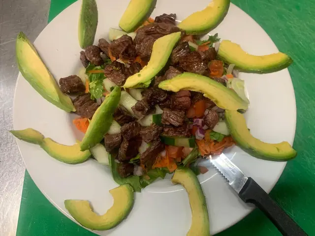 A plated steak and avocado salad from Best Diner